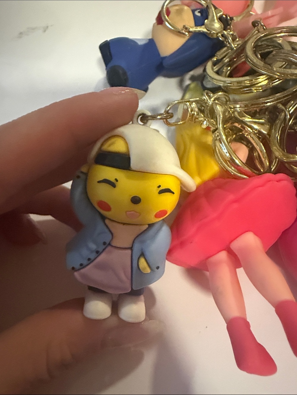 Cute Yellow Character Keychain with Blue Jacket and White Cap